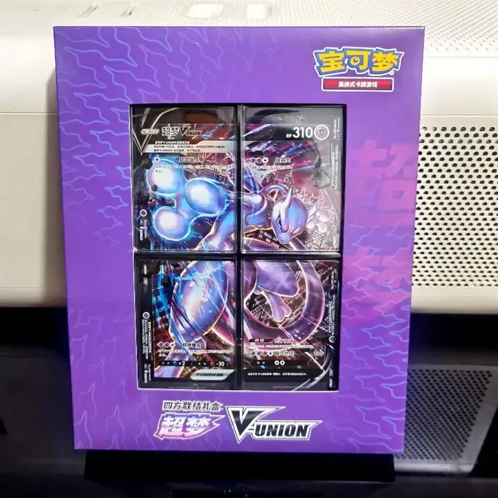 Purple physical Mewtwo V-UNION gift presentation with 超梦 lettering and linked Mewtwo artwork across four front panels