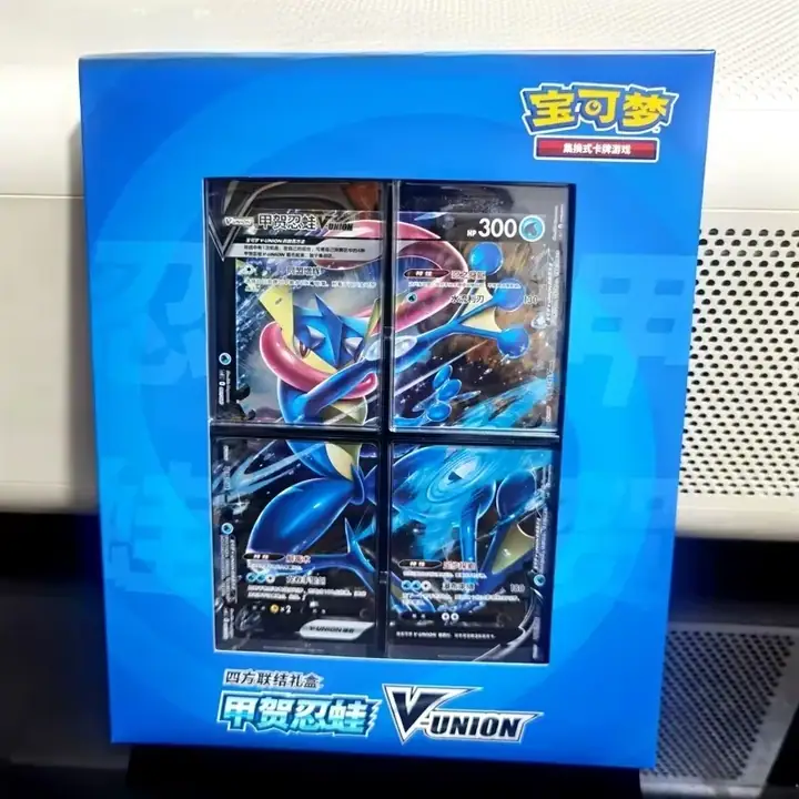 Blue physical Greninja V-UNION presentation with 甲贺忍蛙 lettering and a four-panel Greninja illustration visible through the front