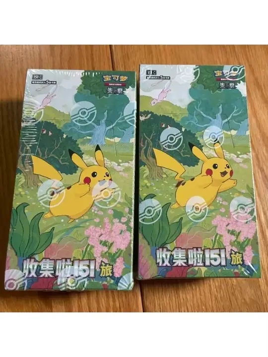 Two green Pikachu-and-Mew 151 Vol.1 packages on wood, shown as a one-Slim-box ordering reference