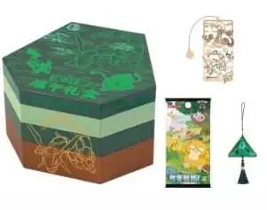 Small green tiered hexagonal Dragon Boat gift montage with a slim metal-coloured item, hanging ornament and pack-like rectangle beside the box