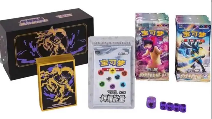 Shadow Rider Calyrex gold line artwork on a black gift box with a matching illustrated sleeve and purple dice